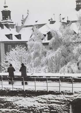 View of the roofs of burgher houses in Mostowa St. and the roof of St. Hyacinth’s Church in winter
