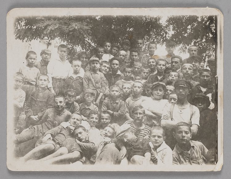 Fotografia przedstawiająca Janusza Korczaka (Henryka Goldszmita) w otoczeniu dzieci w filii Domu Sierot Różyczka (Gocławek)