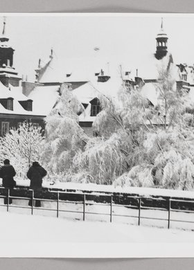 View of the roofs of burgher houses in Mostowa St. and the roof of St. Hyacinth’s Church in winter