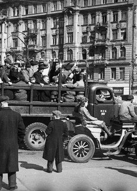 Skrzyżowanie ulicy Brackiej z Alejami Jerozolimskimi. Ciężarówka Miejskiego Zakładu Komunikacji zaadaptowana do przewozu ludzi, w tle kamienica Zofii Kiersnowskiej przy ulicy Brackiej 18
