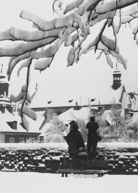 View of the roofs of burgher houses in Mostowa St. and the roof of St. Hyacinth’s Church in winter