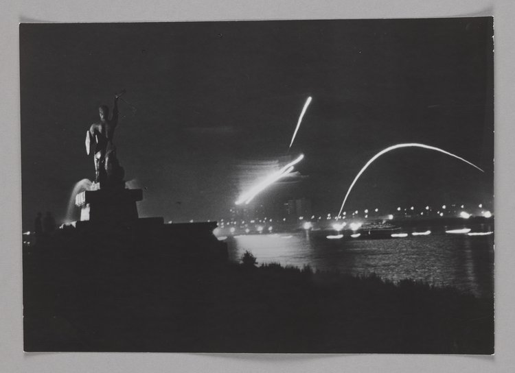 The Mermaid statue by the Vistula and a firework display at night