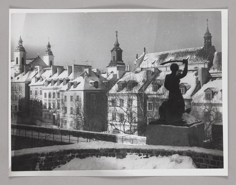 The Mermaid statue on the defensive walls in winter; burgher houses in Mostowa St. in the background